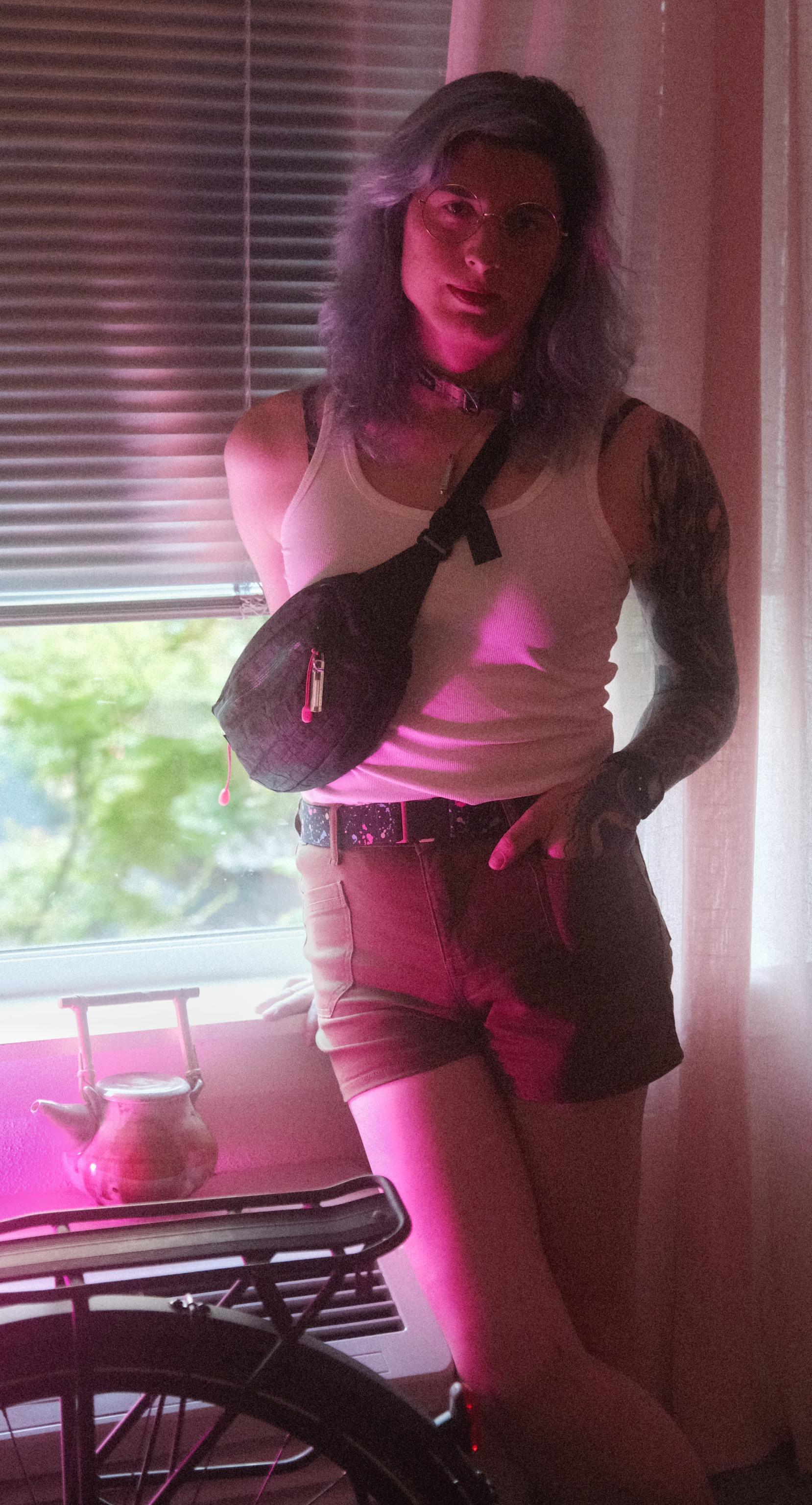 raven posing for the camera in her summer fit with her bike in the background