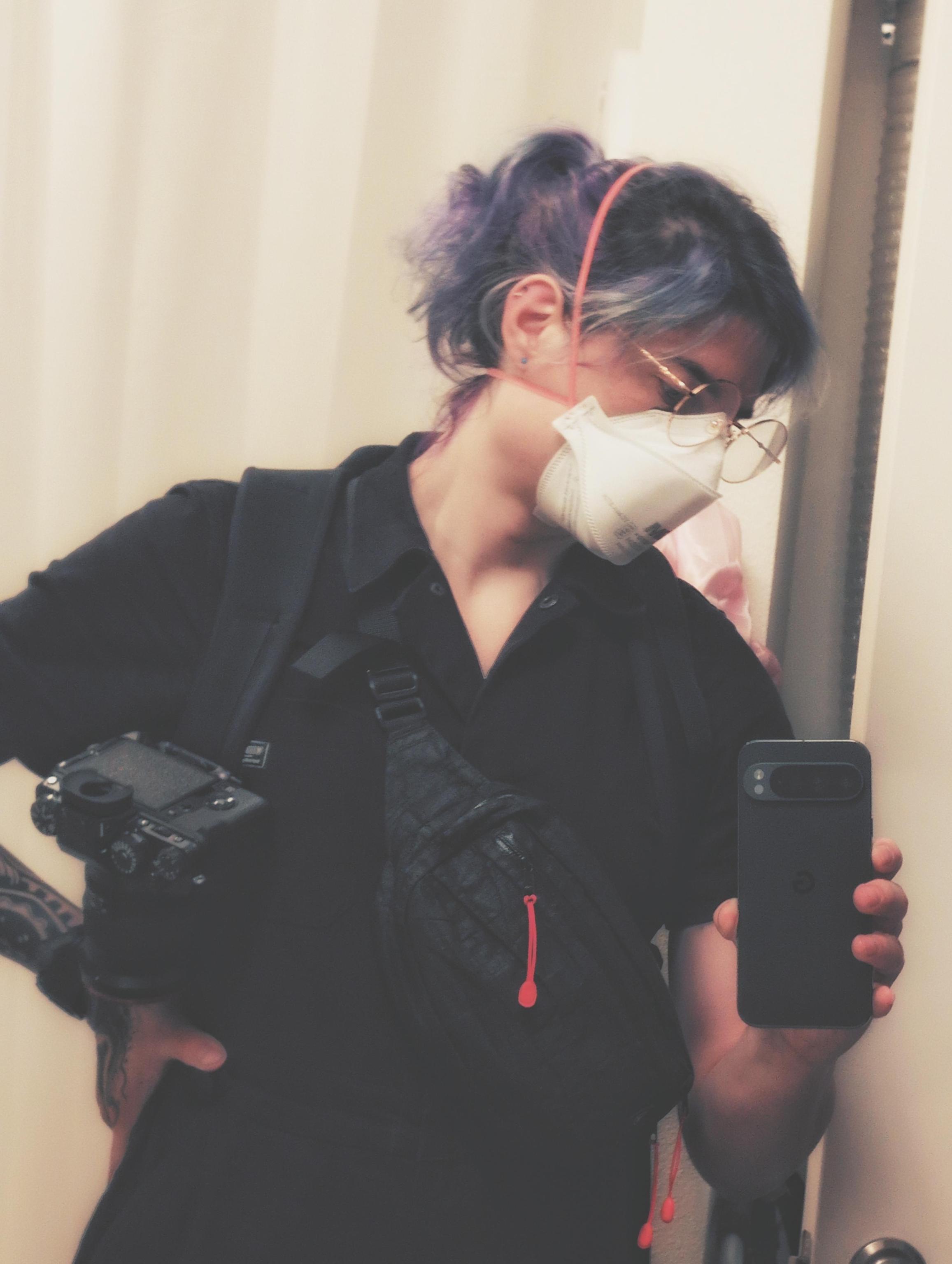 raven selfie with a n95 and her gear including her camera