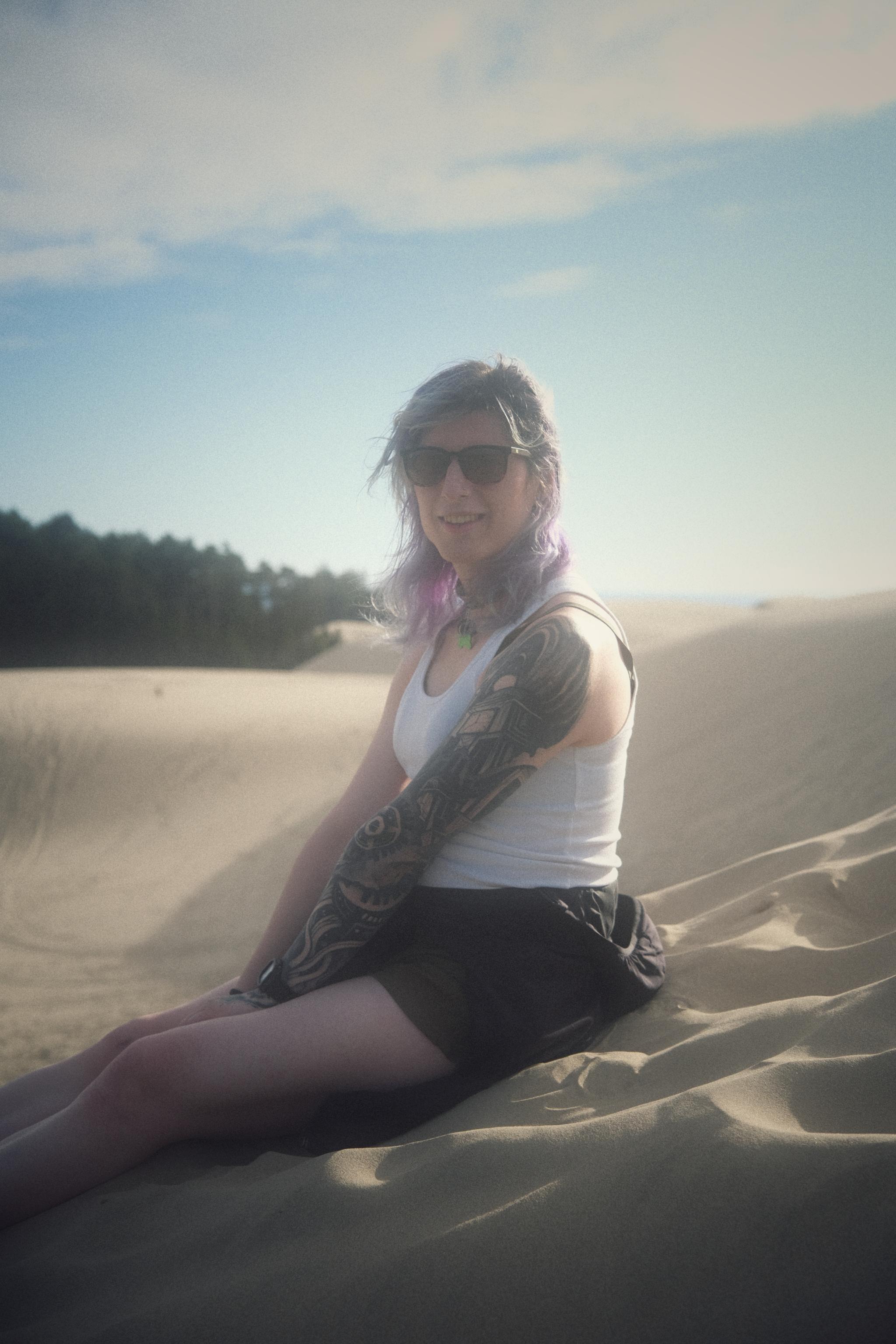 raven sitting in the sand at the Oregon Dunes