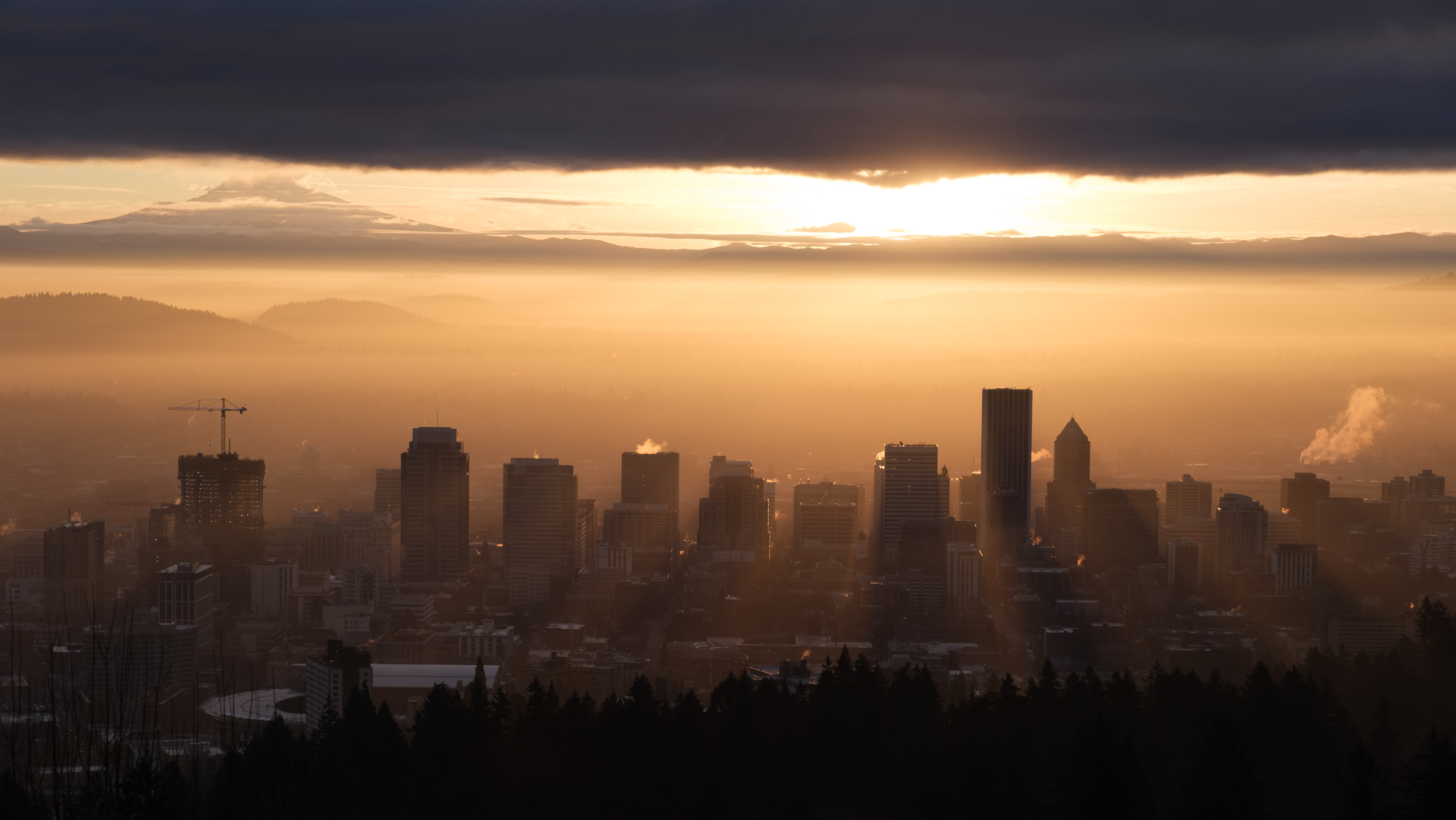 the portland, oregon city skyline at dawn with mt. hood on the left