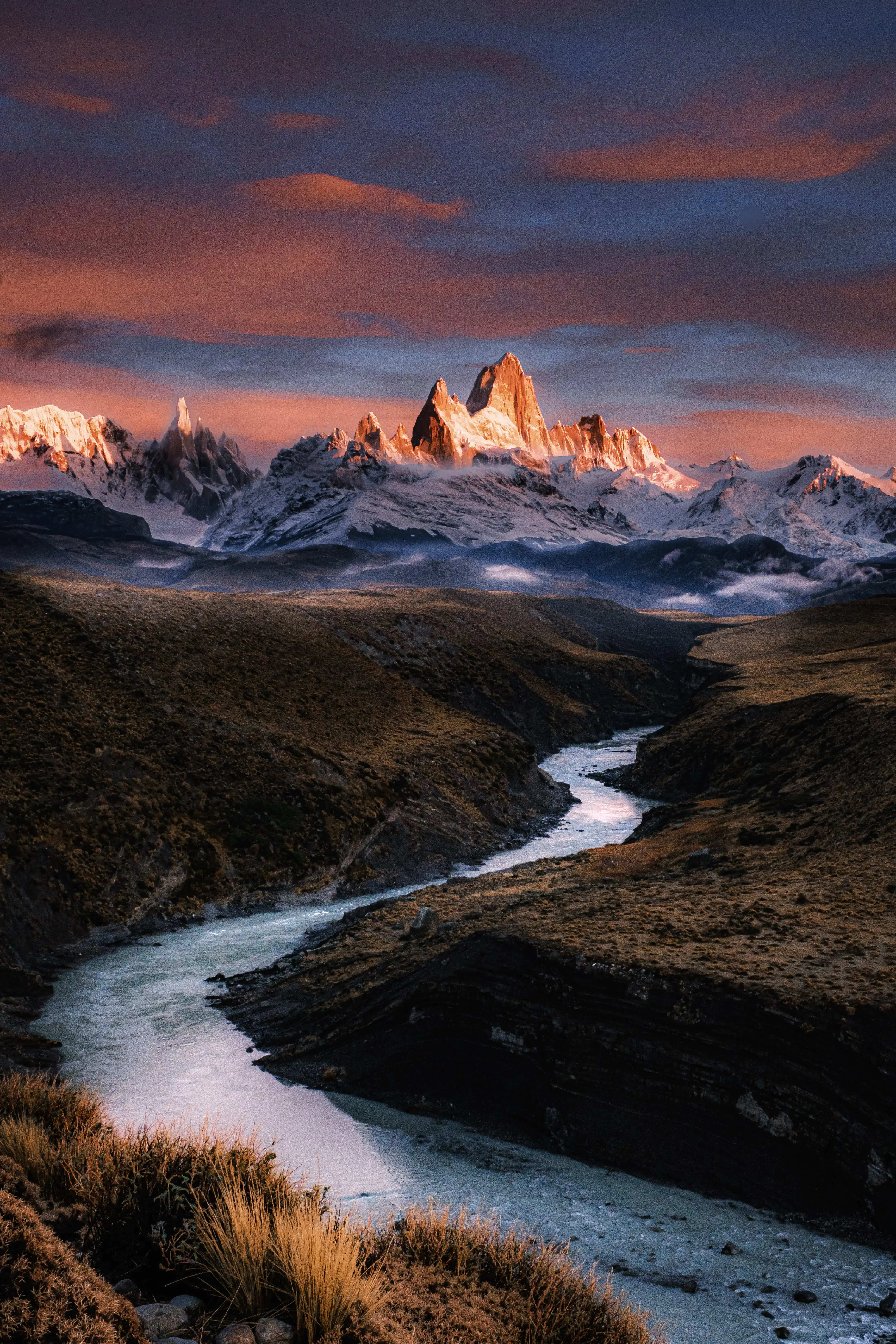 the patagonia mountain range and a river flowing from the mountains