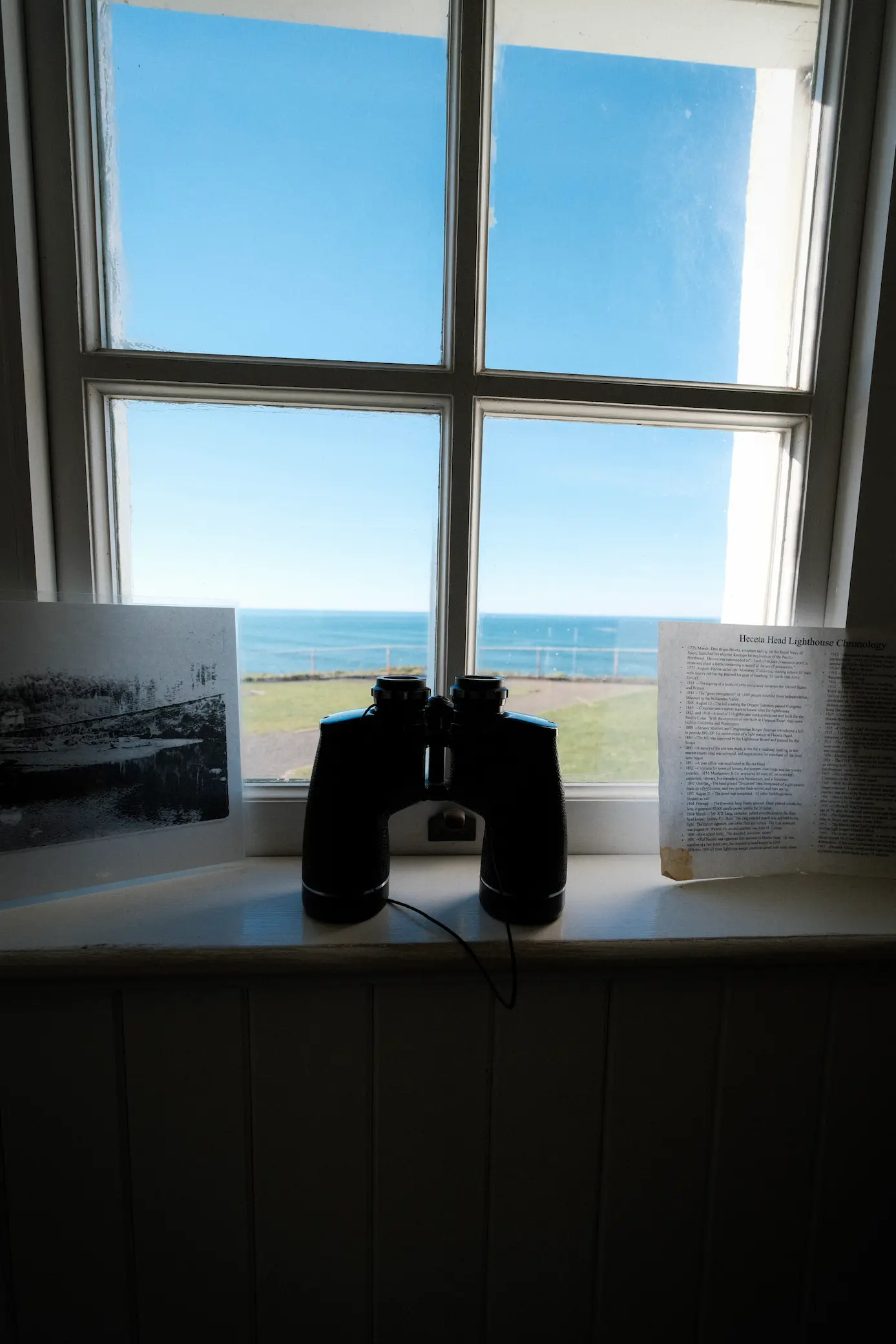 Photo of window with binoculars on the window sill
