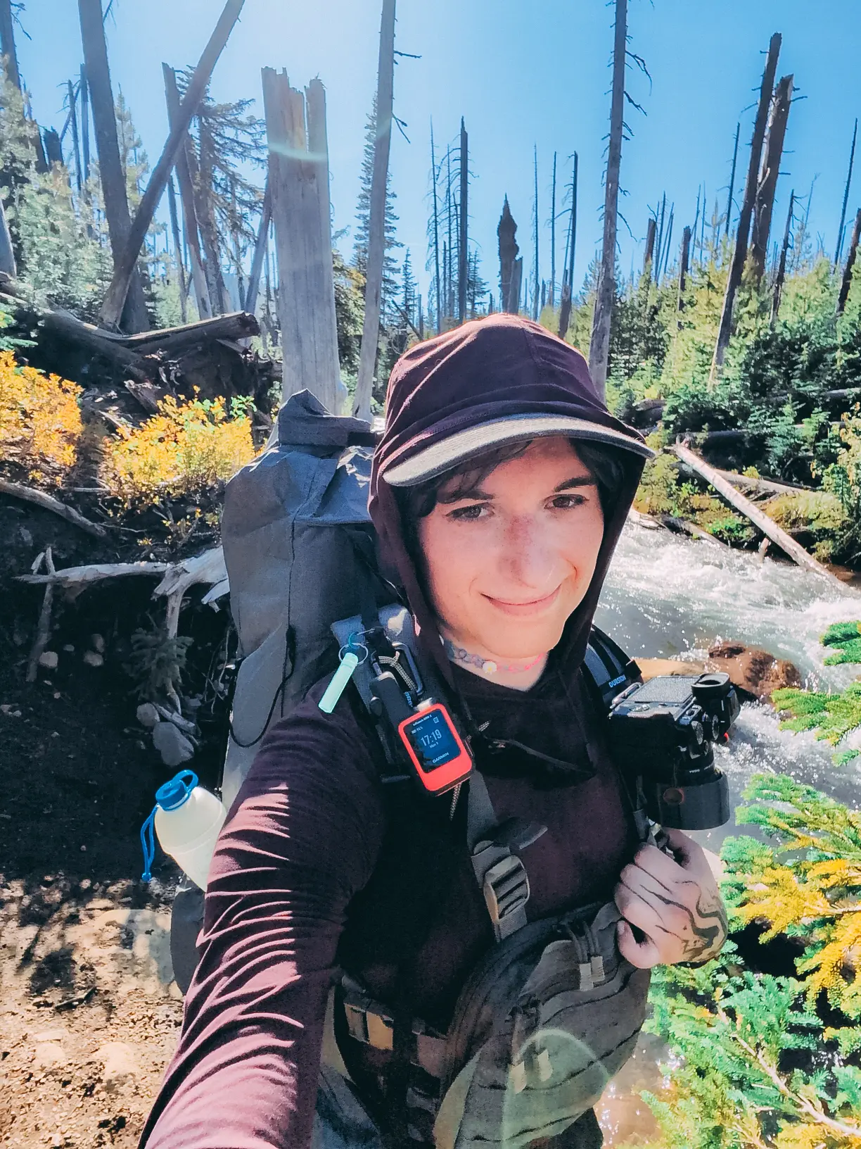 image of the author in a forest with the fujifilm x-t4 mounted on their backpack