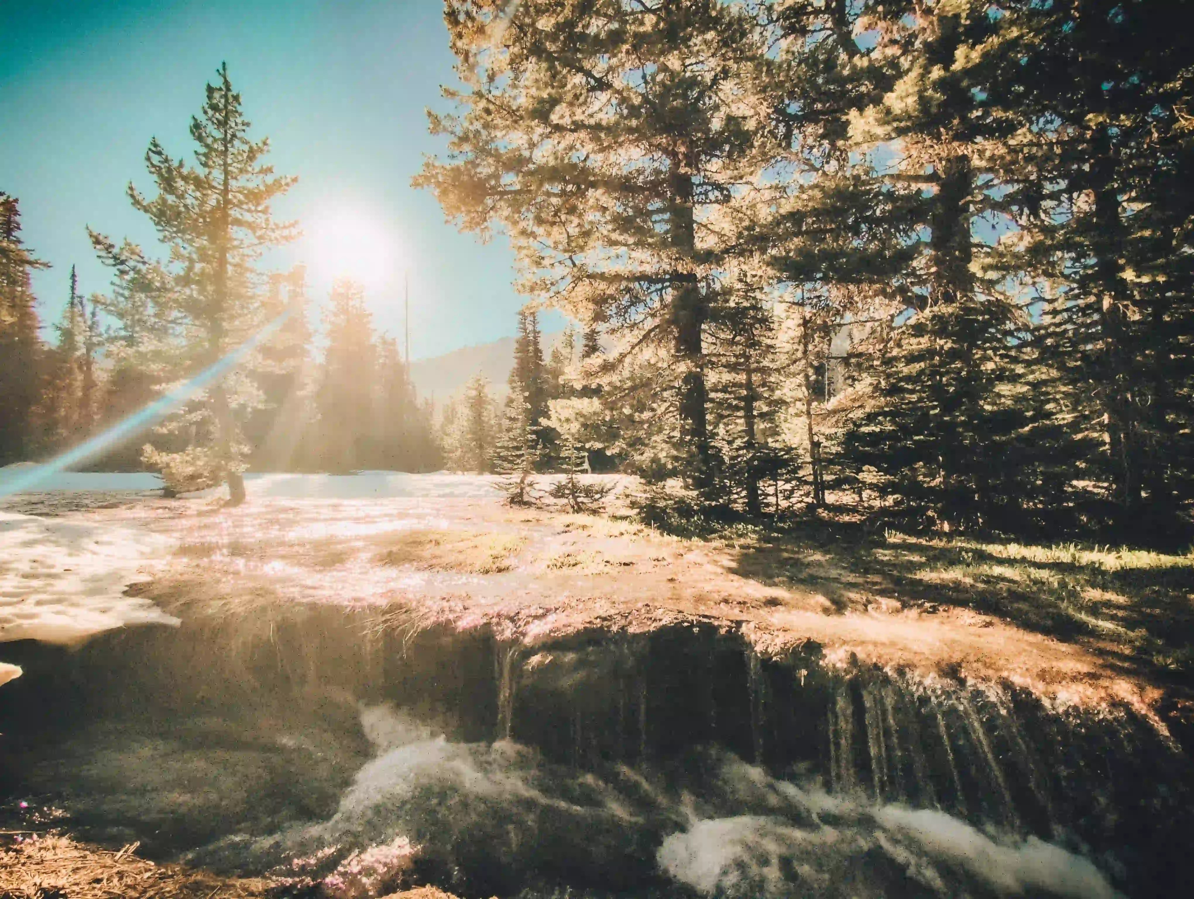 overflowing creek with the sun setting