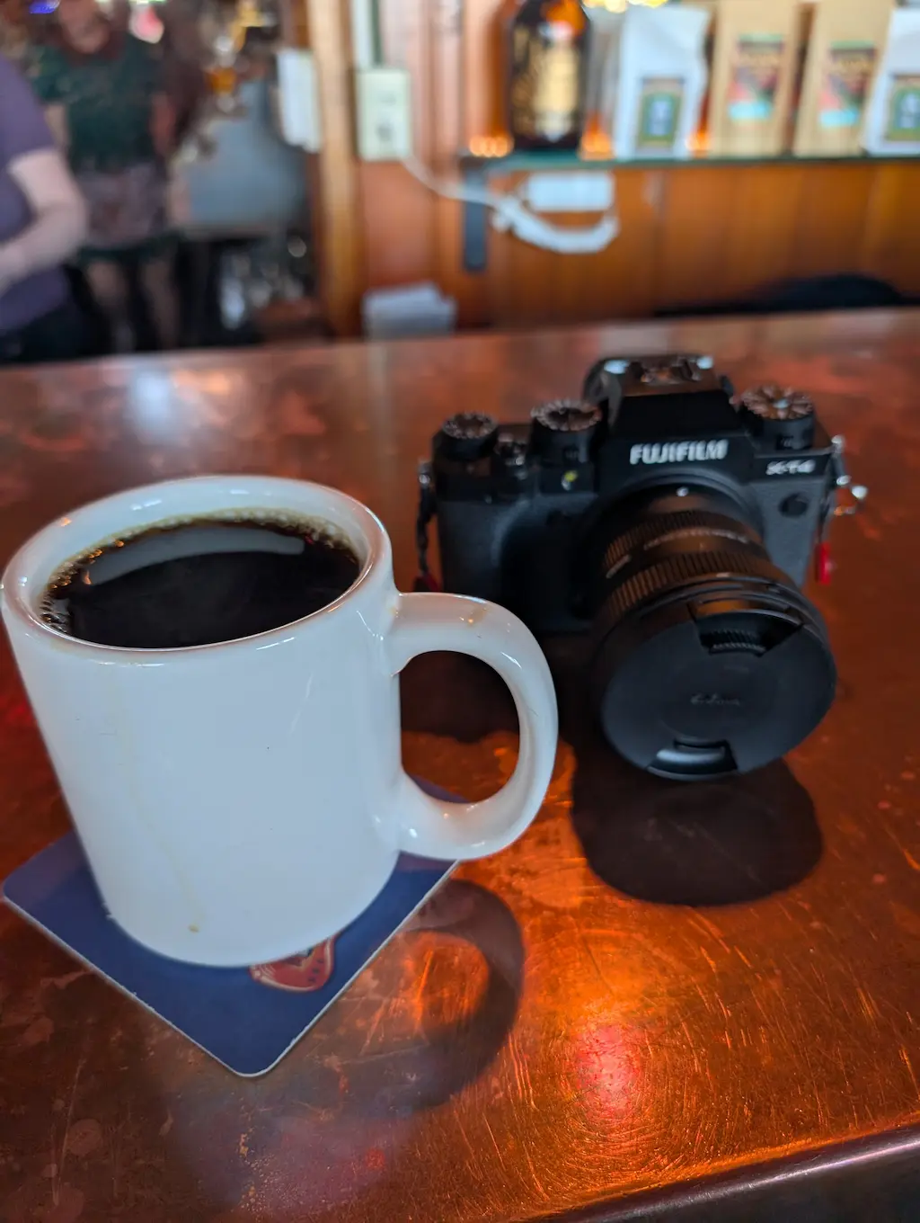 coffee cup and camera at a bar