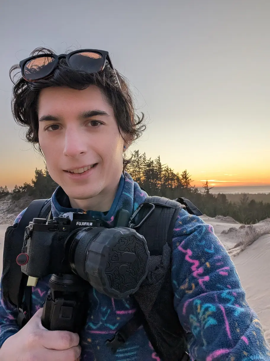 selfie of person holding camera at the beach