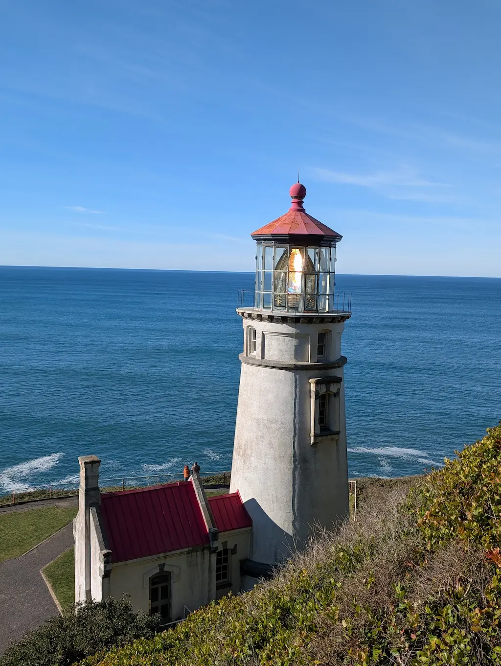 Lighthouse with light on and ocean in the background