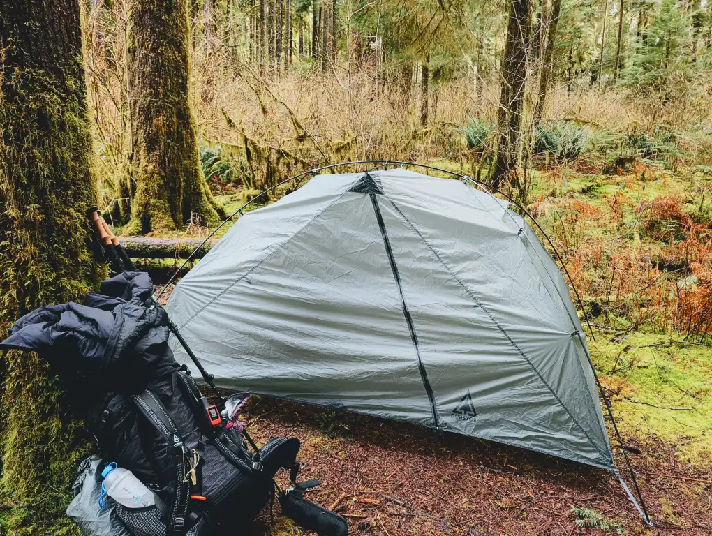 tent and backpack in the forest