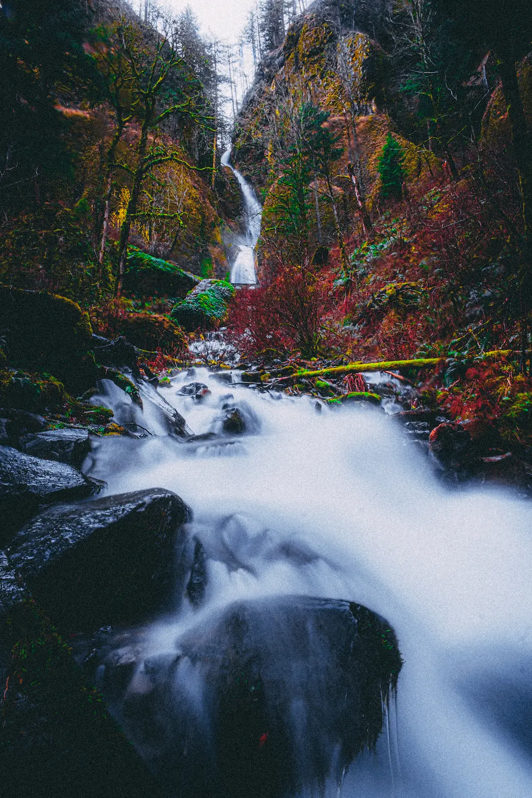 photo of a creek that is blurred due to long exposure which is flowing from a waterfall in the Columbia River Gorge in Oregon