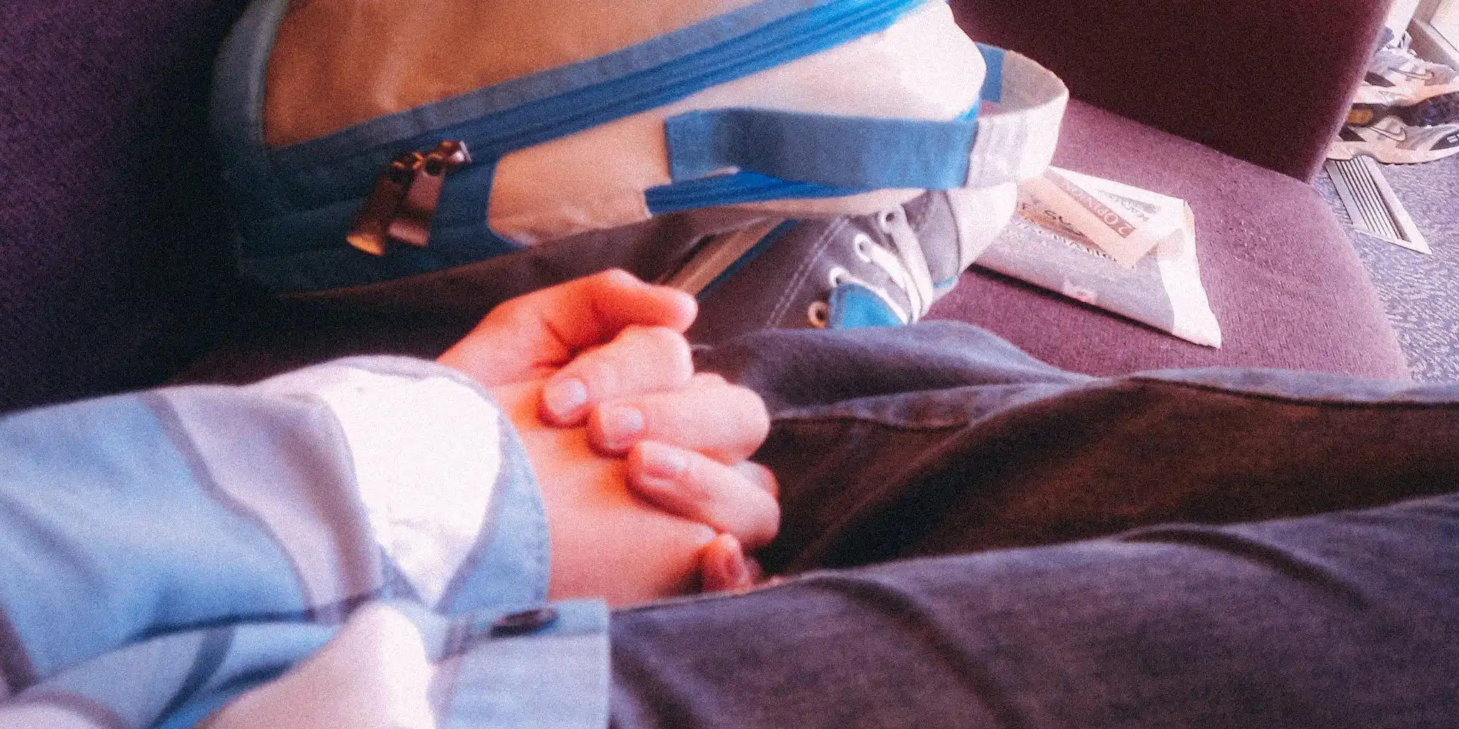 author looking at the camera holding a peace sign, smiling, with mountains behind her